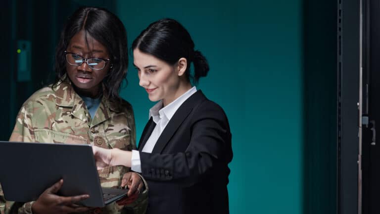 Two female IT engineers setting up server network